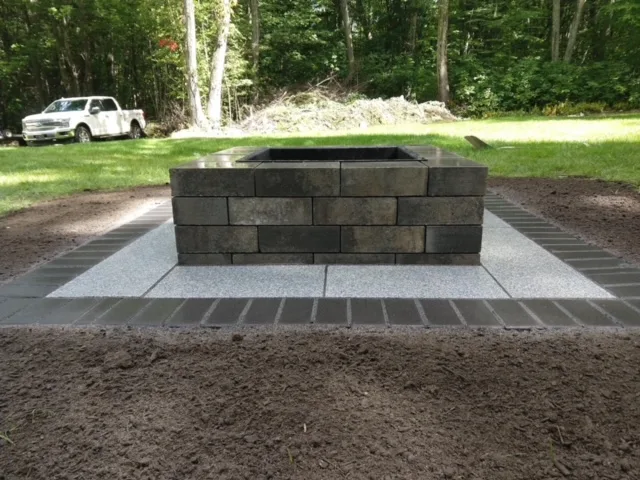 Square paver fire pit on a gravel base built by Miller Mowing & Landscape