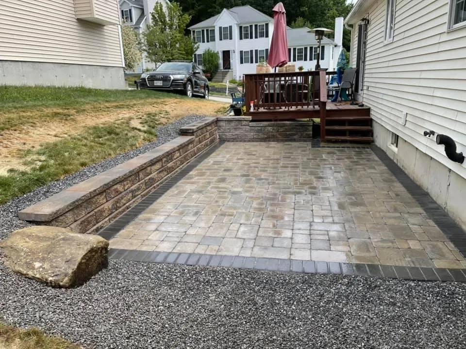 Raised paver patio with boulder accent