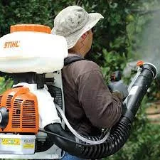 Miller technician applying a backyard mosquito and tick barrier with a backpack sprayer